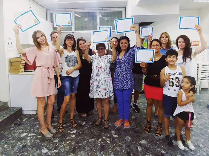 ulpan members holding a certificate